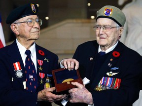 First Special Service Force veterans Eugene Gutierrez (left) and Charles Mann, of Canada, pose with the Congressional Gold Medal at the U.S. Capitol in Washington, D.C., Feb. 3, 2015. (JONATHAN ERNST/Reuters)