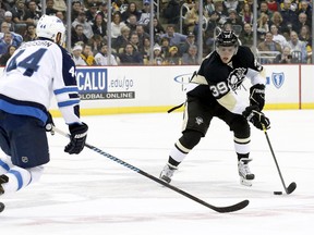 David Perron carries the puck against Jets defenceman Zach Bogosian in late January. (USA TODAY SPORTS)