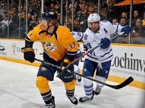 Joffrey Lupul of the Toronto Maple Leafs hooks the stick of Colin Wilson of the Nashville Predators on Feb. 3. (Getty/AFP)