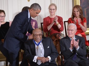 US President Barack Obama presents the Medal of Freedom to former professional golfer Charles Sifford during a ceremony in the East Room of the White House on November 24, 2014 in Washington, DC. The Medal of Freedom is the country highest civilian honor. AFP PHOTO/Mandel NGAN