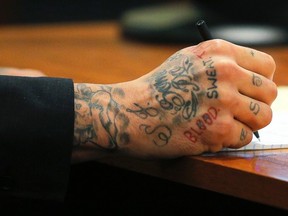 Former Patriots tight end Aaron Hernandez writes a note during his murder trial at Bristol County Superior Court in Fall River, Mass., on Wednesday, Feb. 4, 2015. (Brian Snyder/Reuters)