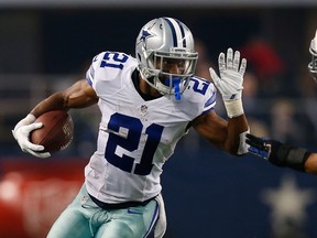 Joseph Randle #21 of the Dallas Cowboys carries the ball as Jerrell Freeman #50 of the Indianapolis Colts tries to position for the tackle in the first half at AT&T Stadium on December 21, 2014 in Arlington, Texas. (Tom Pennington/Getty Images/AFP)