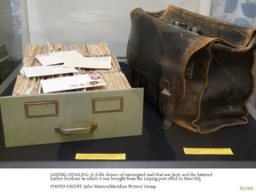 A file drawer of intercepted mail that was kept, and the battered leather briefcase in which it was brought from the Leipzig post office to Stasi HQ in Leipzig, Germany. JOHN MASTERS/MERIDIAN WRITERS' GROUP