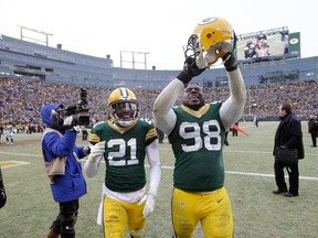Ha Ha Clinton-Dix (21) and Letroy Guion of the Green Bay Packers celebrate after the Packers defeat the Dallas Cowboys 26-21 during the 2015 NFC Divisional Playoff game at Lambeau Field on January 11, 2015. (Mike McGinnis/Getty Images/AFP)