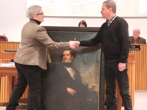 The Judith & Norman Alix Art Gallery added an oil portrait of John Lambton, The Earl of Durham and the county's namesake, to its collection Wednesday. Pictured here is curator Lisa Daniels receiving the painting from Scott Ferguson. BARBARA SIMPSON/THE OBSERVER/QMI AGENCY