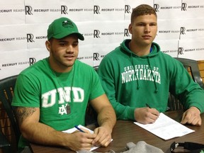 Running back Brady Oliveira (left) and offensive lineman Zack Williams signed on the dotted line with the University of North Dakota in front of family, friends and the media Wednesday.