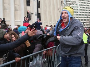 Tight end Rob Gronkowski of the New England Patriots high fives fans during their Super Bowl victory parade February 4, 2015 in Boston. (Billie Weiss/Getty Images/AFP)