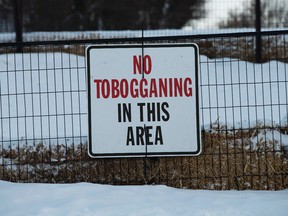 A no tobogganing sign in Gallagher Park, 95 Street - 96 Avenue, in Edmonton Alta., on Tuesday Feb. 3, 2015. A man was killed while tobogganing in the area Sunday Jan. 31, 2015. David Bloom/Edmonton Sun