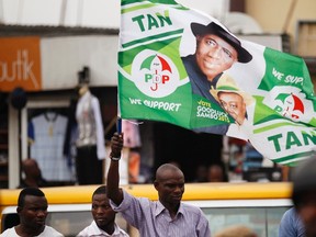 A man holds a flag in support of Nigerian President Goodluck Jonathan at a campaign rally for Lagos governorship candidate Jimi Agbaje of the People's Democratic Party (PDP) in Ikeja district in Lagos February 3, 2015.  REUTERS/Akintunde Akinleye