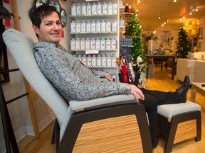 Joseph Branco, owner of Quantum on Richmond Street near Dufferin sits in a grey glider made by Dutailier in Quebec, at his store. 
(Mike Hensen/The London Free Press)
