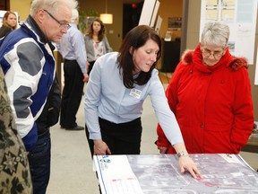 JASON MILLER/The Intelligencer 
City of Belleville Senior Project Manager (Engineering and Development Services) Deanna O'Leary (centre) speaks to Bob and Ruth Mossman at the Build Belleville office Wednesday night.