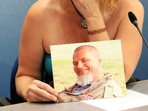 Robyn Schmitke holds a photo of her missing husband Valentine Leo Degenhardt as she speaks to the media at RCMP K Division, in Edmonton, Alta., Wednesday Aug. 28, 2013. Degenhardt was last seen near Barrhead, Alta. on July 17, 2013. The Degenhardt family are offering a reward for information on his disappearance. David Bloom/Edmonton Sun/QMI Agency