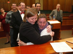 Mary Black (L) and her wife Sarah Weinstein hug after being married in a group wedding by Oakland County Clerk Lisa Brown at the Oakland County Courthouse after a Michigan federal judge ruled a ban on same-sex marriage violates the U.S. Constitution and must be overturned in Pontiac, Michigan March 22, 2014.  REUTERS/Rebecca Cook