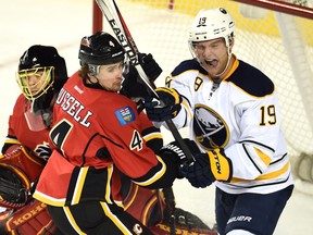 Calgary Flames defenceman Kris Russell tangles with Buffalo Sabres center Cody Hodgson in front of the net during the third period at Scotiabank Saddledome on Jan. 27, 2015. (Candice Ward/USA TODAY Sports)