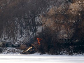 A freight train, owned by Canadian Pacific Railway, carrying ethanol fuel with one car engulfed in flames, sits on the banks of the Mississippi River in a remote location north of Dubuque, Iowa in this February 4, 2015 picture provided by Dubuque Telegraph Herald. There were no injuries or fatalities involved in the accident, said Jeremy Berry, spokesman for the railway.  REUTERS/Mike Burley/Dubuque Telegraph Herald/Handout via Reuters