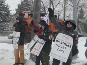 Ontario Nurses’ Association members stand on the picket line outside the Community Care Access Centre’s office on Sir John A. Macdonald Boulevard on Wednesday. (Elliot Ferguson/The Whig-Standard)