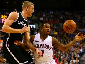 Raptors' Kyle Lowry tries to grab the ball while being defended by Mason Plumlee of the Brooklyn Nets on Feb. 4 (Dave Abel, Toronto Sun)