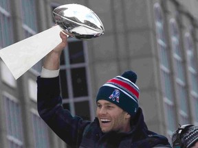 Patriots QB Tom Brady lifts the Lombardi Trophy during the Super Bowl victory parade in Boston on Wednesday. (USA TODAY SPORTS)