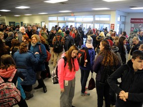 Students fill the lobby of the Gemini Sports Complex in Strathroy Thursday, Feb. 5, after a gas leak was discovered at Holy Cross and Strathroy District Collegiate Institute.