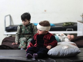 Injured children rest in a field hospital after what activists said were air strikes by forces loyal to Syria's President Bashar al-Assad in Douma eastern Al-Ghouta, near Damascus on Jan. 25. Islamist fighters struck the Syrian capital with at least 38 rockets, killing seven people, a monitoring group said, in one of heaviest attacks on Damascus in over a year. (Badra Mamet/Reuters)