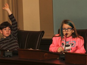 Dylan VanDusen, left, and Maddy MacKenzie from Mr. Pottery's Grade 4-5 class at Frontenac Public School, share their reflections on the days learning in council chambers in Kingston City Hall as part of the Beyond Classrooms Kingston program on Thursday. Beyond Classrooms Kingston gives classes the opportunity to get out of their school settings and spend a week of learning in a local museum or community site. (Julia McKay/The Whig-Standard)