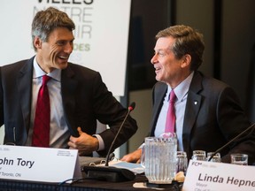 Toronto Mayor John Tory (R) laughs with Vancouver Mayor Gregor Robertson  during the Canadian Federation of Municipalities "Big City Mayors" conference in Toronto, February 5, 2015.  (REUTERS/Mark Blinch)