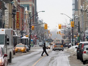 A pedestrian crosses Dundas St., west of Wellington Rd., in London, Ontario on Wednesday February 4, 2015. (CRAIG GLOVER, The London Free Press)