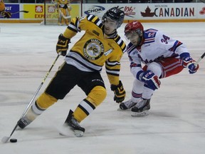 Sarnia Sting forward Daniel Nikandrov protects the puck from Kitchener Rangers defenceman Max Iafrate during the Ontario Hockey League game at RBC Centre in Sarnia on Thursday night. The Sting defeated the Rangers 3-0 to pull within one point of each other in the standings. (TERRY BRIDGE, The Observer)
