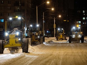 Graders begin clearing snow along Jasper Avenue near 121 Street, on Thursday Feb. 5, 2015. David Bloom/Edmonton Sun/QMI Agency