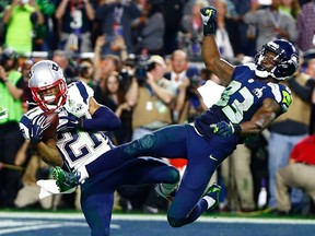 New England Patriots strong safety Malcolm Butler (21) intercepts a pass intended for Seattle Seahawks wide receiver Ricardo Lockette (83) in the fourth quarter in Super Bowl XLIX at University of Phoenix Stadium in Glendale, Arizona February 1, 2015. REUTERS/Mark J. Rebilas-USA TODAY Sports