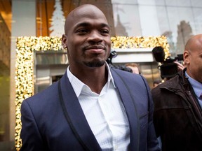 Suspended Minnesota Vikings running back Adrian Peterson (L) exits following his hearing against the NFL over his punishment for child abuse, in  New York in this December 2, 2014 file photo.   REUTERS/Brendan McDermid/Files