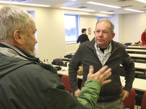 Seeley's Bay farmer Charlie Forman, right, talks with a member of the audience after giving a speech to Switch, the organization that promotes green energy, about his farming operation. FRI., FEB 6, 2015 KINGSTON, ONT. MICHAEL LEA THE WHIG STANDARD QMI AGENCY