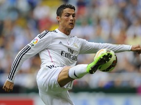 In this photo taken on September 20, 2014 Real Madrid's Portuguese forward Cristiano Ronaldo controls the ball during the Spanish league football match RC Deportivo de la Coruna vs Real Madrid CF at the Municipal de Riazor stadium in La Coruna.  AFP PHOTO/ MIGUEL RIOPA