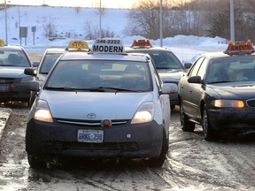 Taxis pick up and drop off passengers at the Kingston Via Train station on Friday. (Ian MacAlpine/The Whig-Standard)