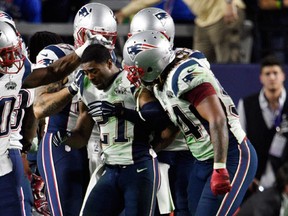 New England Patriots strong safety Malcolm Butler (21) celebrates with teammates after intercepting a pass against the Seattle Seahawks in the fourth quarter in Super Bowl XLIX at University of Phoenix Stadium. Kyle Terada-USA TODAY Sports