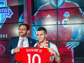 Sebastian Giovinco (right) poses with his new No. 10 TFC jersey with team GM Tim Bezbatchenko yesterday at the ACC. (Ernest Doroszuk/Toronto Sun)