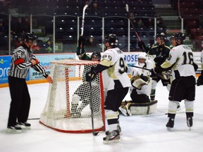 St. Thomas Stars captain Spencer Hutchinson, second from left, raises his stick to celebrate after scoring the first goal of a home game Friday against the LaSalle Vipers. Hutchinson was one of about five players who crowded around LaSalle goalie Paolo Battisti just prior to the goal, appearing to leave the left side of the net off its mooring. (Ben Forrest, Times-Journal)