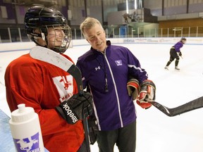Assistant coach Dave Barrett talks to Ali Beres of the Mustangs women?s hockey team during practice at Thompson arena on Friday. (MIKE HENSEN, The London Free Press)