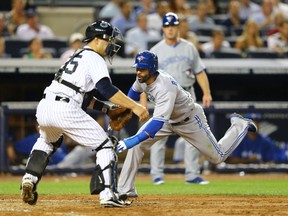 Jose Bautista (right) and catcher Russell Martin — seen here during his Yankee days — are two Blue Jays who have graduated from the Chipola College Indians in Florida. (Getty Images)