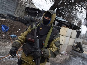 A Pro-Russian separatist fighter mans a checkpoint near the airport of Donetsk on Febuary 7, 2015. AFP PHOTO / DOMINIQUE FAGET