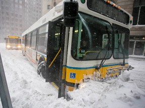 A MBTA bus sits stuck in a snowbank during a snow storm in Boston, Massachusetts February 2, 2015. More snow is on the way for the region. (REUTERS/Dominick Reuter)