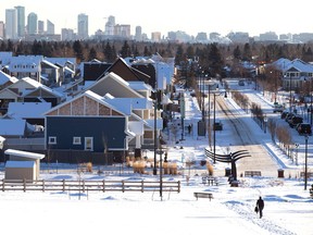 Urban sprawl. A pedestrian walks through the snow towards the new neighbourhood of Griesbach as Edmonton's skyline is visible in the background on Tuesday Feb. 3, 2015. David Bloom/Edmonton Sun/QMI Agency