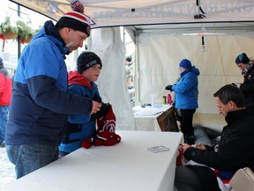 Habs fans; Craig Spencer, and son, Colin, 10, came down to Feb Fest specifically to get an autograph from Guy Carbonneau in Kingston, Ont. on Saturday February 7, 2015. Steph Crosier/Kingston Whig-Standard/QMI Agency