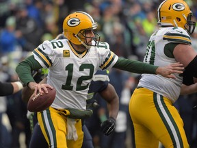 Green Bay Packers quarterback Aaron Rodgers (12) looks to throw the ball against the Seattle Seahawks during the fourth quarter in the NFC Championship Game at CenturyLink Field. Mandatory Credit: Kirby Lee-USA TODAY Sports