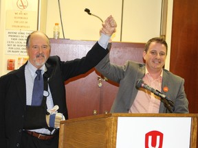 Jason McMichael, right, raises hands with defeated candidate Joe Hill after McMichael was chosen the federal NDP candidate in Sarnia-Lambton Sunday during a nomination meeting at the Unifor union hall in Sarnia. (PAUL MORDEN, The Observer)