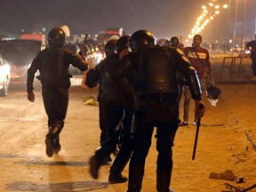 Policemen and soccer fans argue during a scuffle as fans attempt to enter a stadium to watch a match, on the outskirts of Cairo February 8, 2015. (REUTERS)