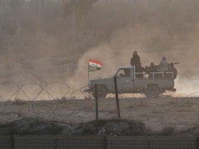 Shiite fighters ride an military vehicle during a military operation to retake positions held by Islamic State militants, on the outskirts of Muqdadiyah in Diyala province, January 25, 2015. Picture taken January 25, 2015. REUTERS/Stringer