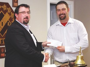 Little Bow MLA Ian Donovan, left, presents Vulcan Kinsmen president Derek Ully with a $40,000 grant that will go towards the Town of Vulcan Recreation Department’s effort to upgrade the skateboard park. Submitted photo