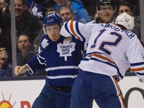 Toronto Maple Leafs'  David Booth (20)  fights  the Edmonton Oilers'  Rob Klinkhammer (12) in Toronto on Saturday February 7, 2015. Craig Robertson/Toronto Sun/QMI Agency