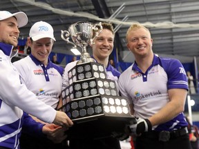 From left: Mark Kean, Mat Camm, David Mathers and Scott Howard hold the trophy after winning the Ontario Men’s Curling Tankard in Dorchester, Ont., yesterday. (GREG COLGAN/QMI Agency)